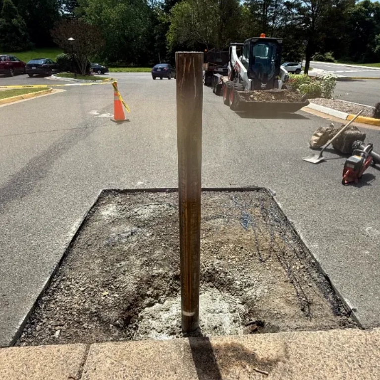 A section of a parking lot is being dug up for asphalt repair.
